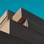A striking view of a modern concrete structure against a vibrant blue sky in London, Ontario.